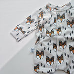 Baby onesie with fox pattern on a light gray background