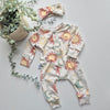 Baby onesie with celestial pattern on a light gray background