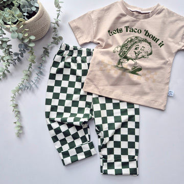Toddler baggy trousers in forest check paired with a Lets Taco 'bout printed t-shirt