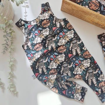 Children's romper with astronaut pattern on a white surface
