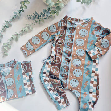 Children's long-sleeve shirt and pants with various patterns on a light background.