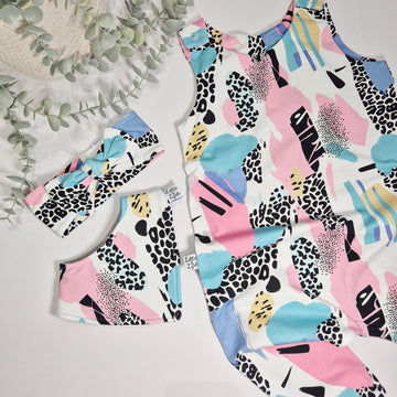 Colorful abstract patterned outfit with matching shoes on a light background