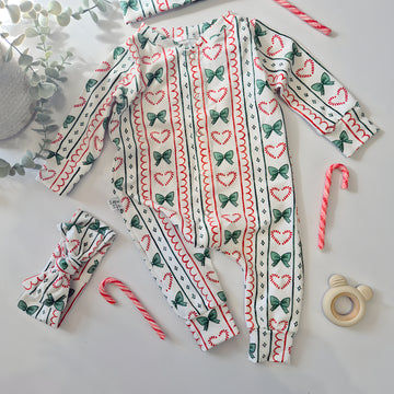 Baby christmas sleepsuit with candy bows print by Lottie & Lysh