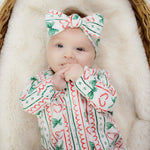 baby girl wearing christmas babygrow by Lottie & Lysh with matching bow headband