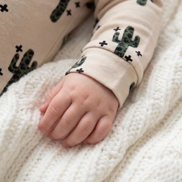 Close up image of a babies wearing a leopard print cactus romper by Lottie & Lysh
