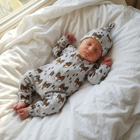 Newborn baby boy wearing Lottie & Lysh Geo Fox print babygrow and hat set