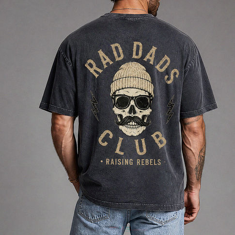 Person wearing a t-shirt with 'Rad Dads Club' design on the back, standing against a gray background.