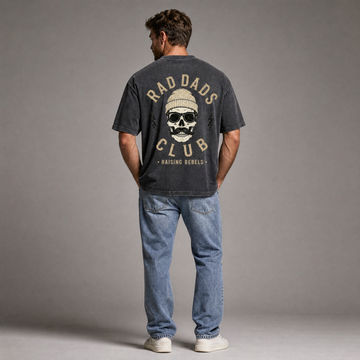 Man wearing a t-shirt with 'Rad Dads Club' design on the back, standing against a gray background.