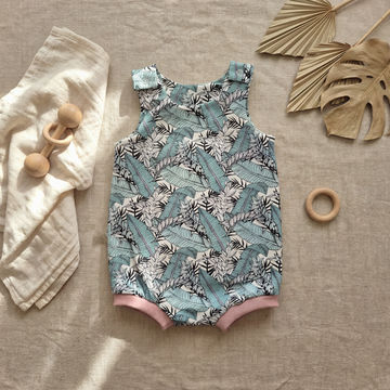 Tropicana summer baby romper flat lay
