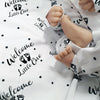 Newborn Baby Coming Home outfit. White and black print with Welcome Little One graphic.