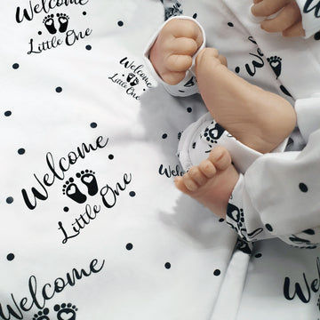 Newborn Baby Coming Home outfit. White and black print with Welcome Little One graphic.