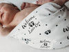 Unisex swaddle blanket with Welcome Little One Unisex Design in black and white.