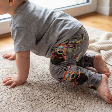 crawling baby wearing geo stags print leggings