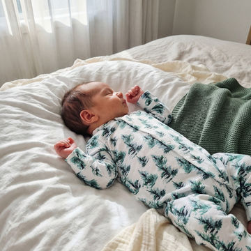 newborn baby wearing tree print baby romper