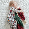 Sleeping baby boy wearing Lottie & Lysh Tattoo Rose print babygrow