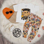 kids white good vibes t-shirt with 70s style leggings and knitted beanie hat