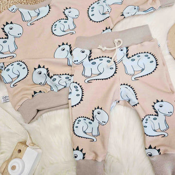 beige sweatshirt and jogging bottoms set for children featuring a dinosaur motif