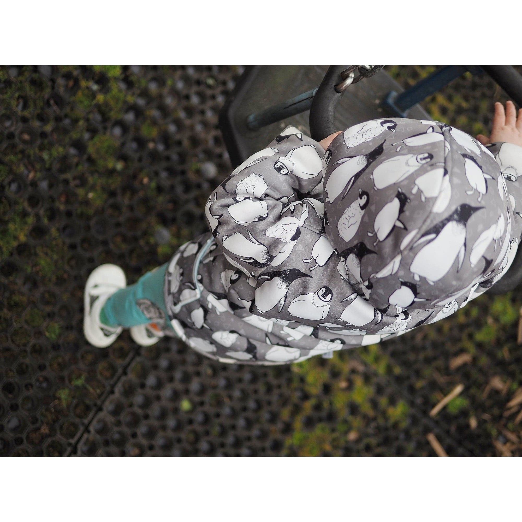 baby boy wearing lottie and lysh penguin waterproof jacket and rhino design leggings