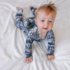 baby boy wearing a lottie and lysh owl print romper featuring a wintery scene