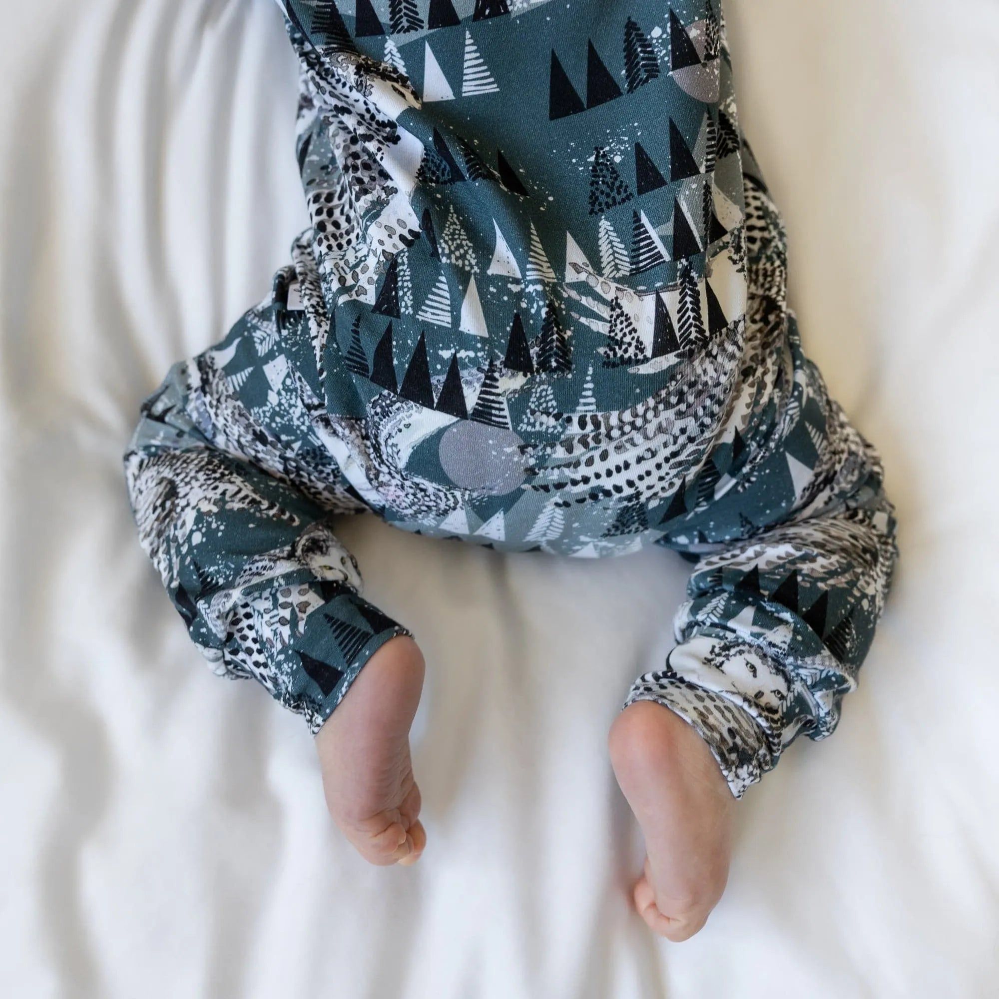 close up photo of the fabric in the Lottie & Lysh Artic owls long leg popper romper for babies and children