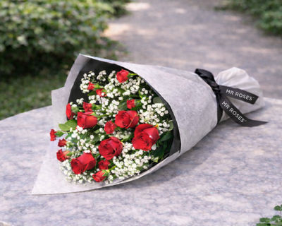 flower bouquet of red roses, baby’s breath and spray carnations