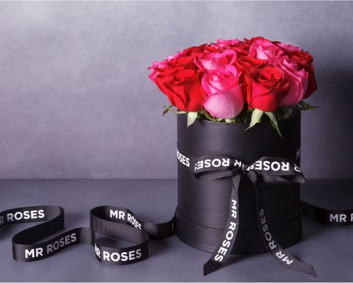 fresh red and pink roses in stylish mr roses hat box