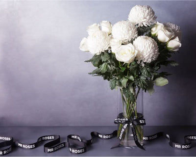 white chrysanthemum and white roses floral arrangement