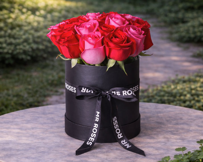 fresh red and pink roses in stylish mr roses hat box