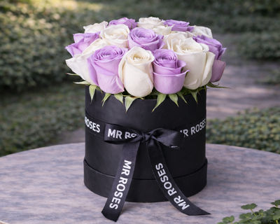 purple and white roses in a hat box