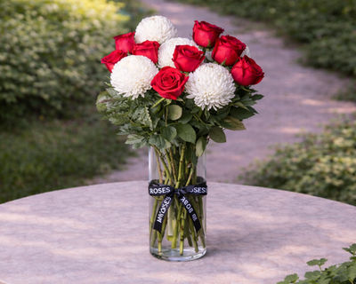 white chrysanthemum and red roses flower arrangement in vase