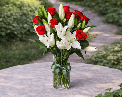 Fragrant white lilies and red roses flower arrangement