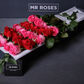 red and pink long stemmed roses in gift box