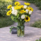 Sunflowers and white roses flower arrangement in vase 