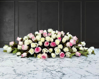 funeral spray of pink and white roses, funeral flowers and casket flowers in white
