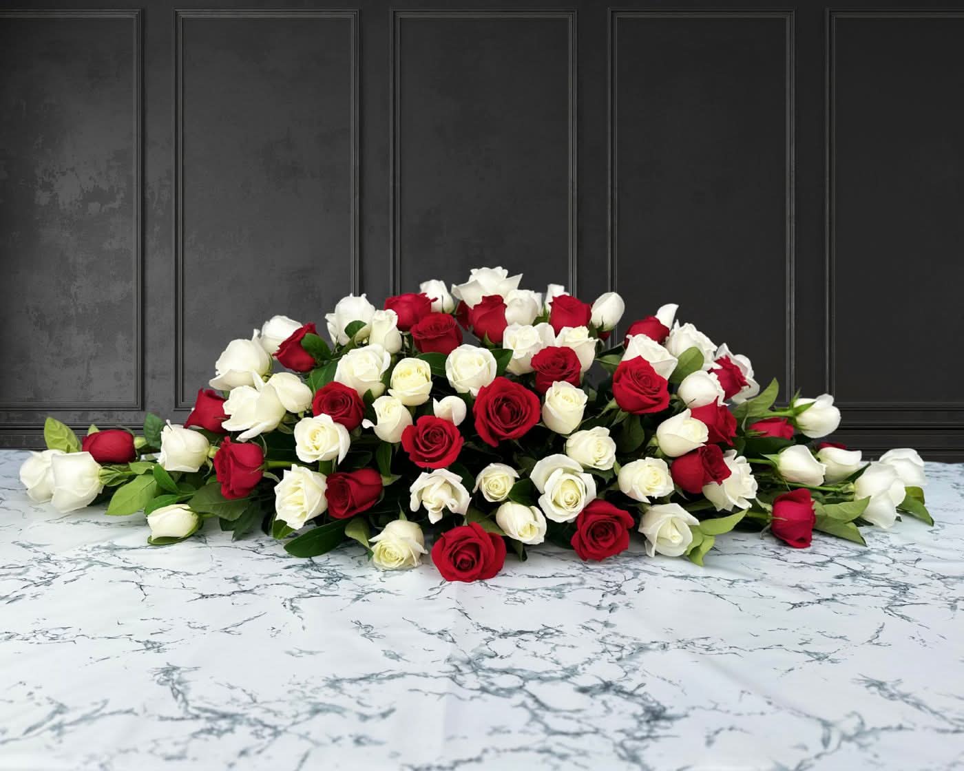 funeral spray of red and white roses, funeral flowers and casket flowers in white
