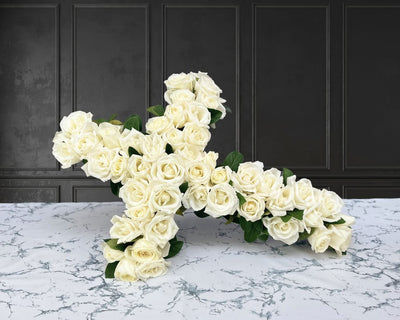 white rose cross wreath. Funeral flowers and casket flowers