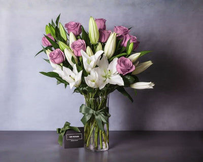 white lilies and purple roses vase