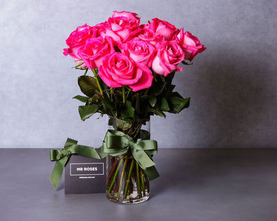 medium stemmed pink roses in a vase
