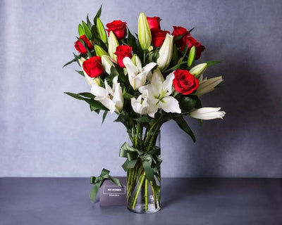 Fragrant white lilies and red roses flower arrangement