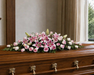 stunning pink rose and lily funeral flowers - casket spray