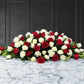funeral spray of red and white roses, funeral flowers and casket flowers in white