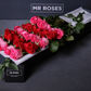 red and pink long stemmed roses in gift box
