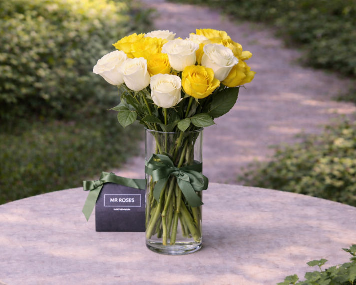 long stemmed yellow and white roses