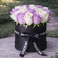 purple and white roses in a hat box