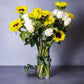 Sunflowers and white roses flower arrangement in vase 