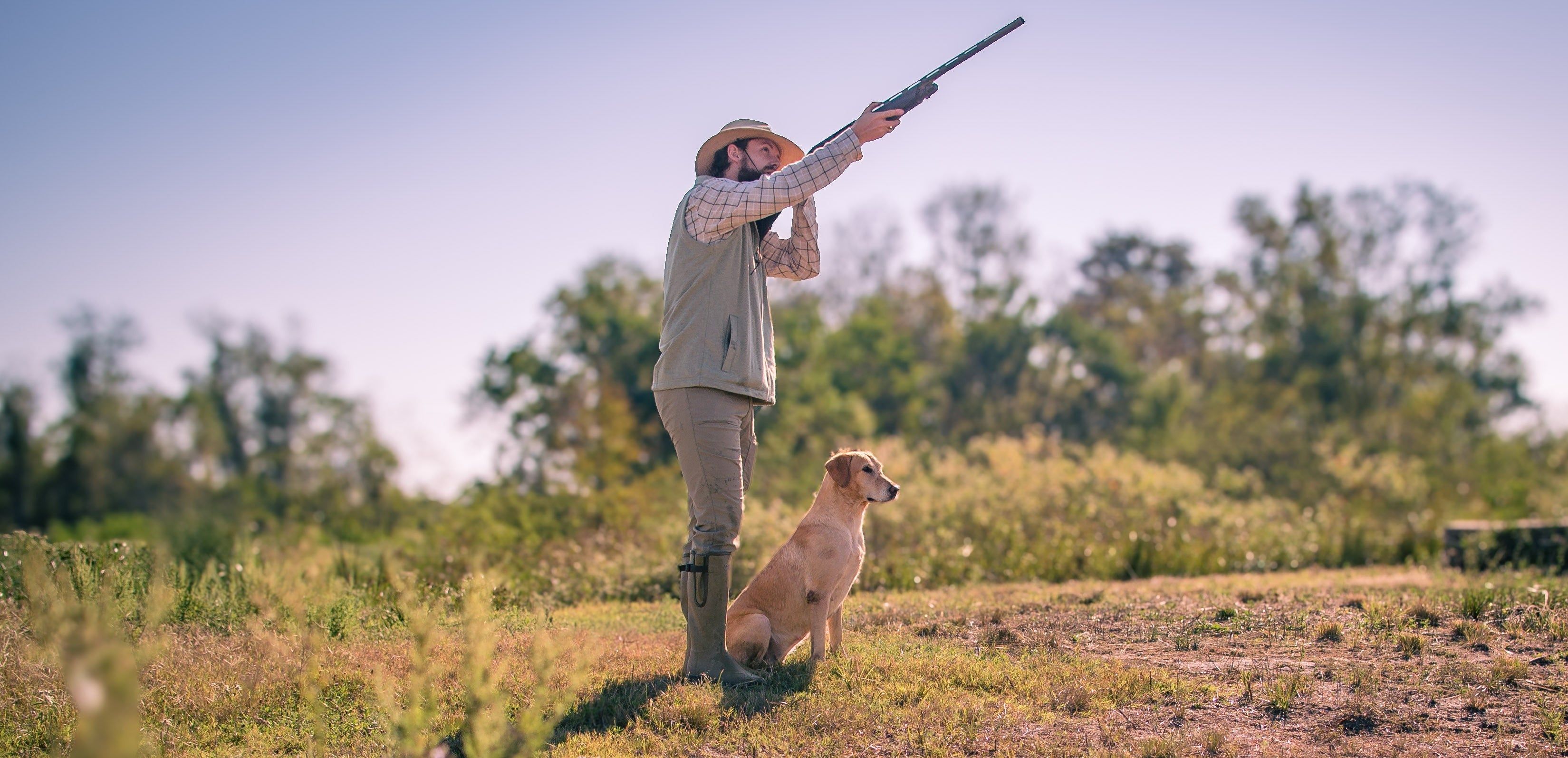 Trainer in with a dog in the field, shooting a shotgun. Taking advantage of the wonderful training grounds at TGC is just one of the perks of membership.
https://www.daniellewesthoustonphotography.com/