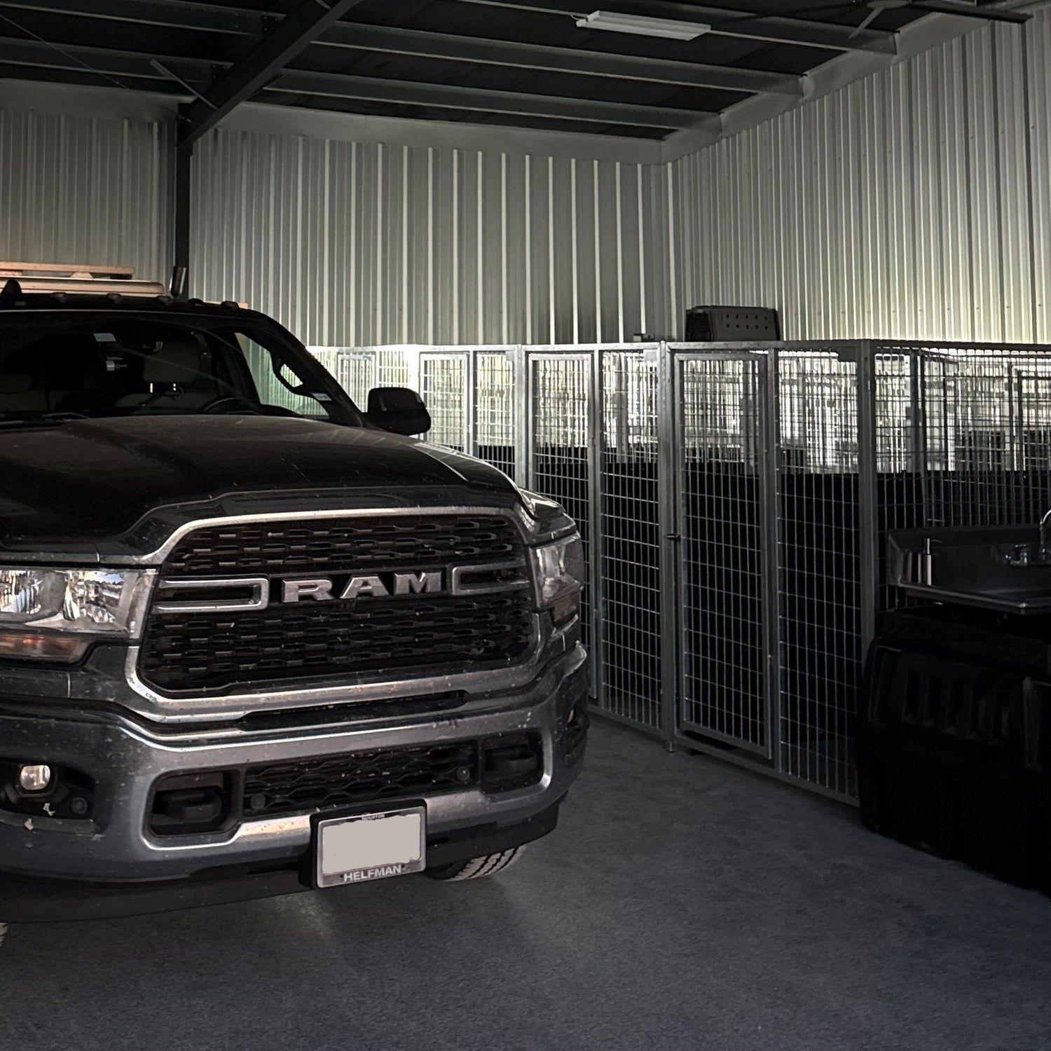 Black Ram truck inside The Gundog Club's kennel, with galvanized kennels all around