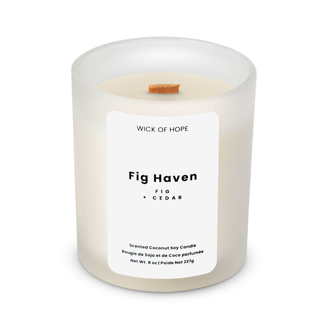 The Wick of Hope Fig Haven Candle | Fig + Cedar is a non-toxic coconut soy wax candle in white frosted glass, featuring an earthy scent, wooden wick, and a simple, minimalistic label.
