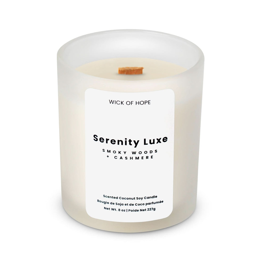 The Wick of Hope Serenity Luxe Candle, Smoky Woods + Cashmere, is a luxury coconut soy wax candle in a frosted glass jar with a wooden wick. Net Wt. 8 oz.