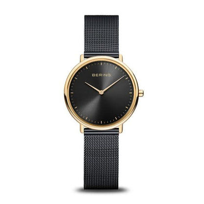 Montre Bering pour femme avec cadran noir, boîtier doré et bracelet milanais noir.